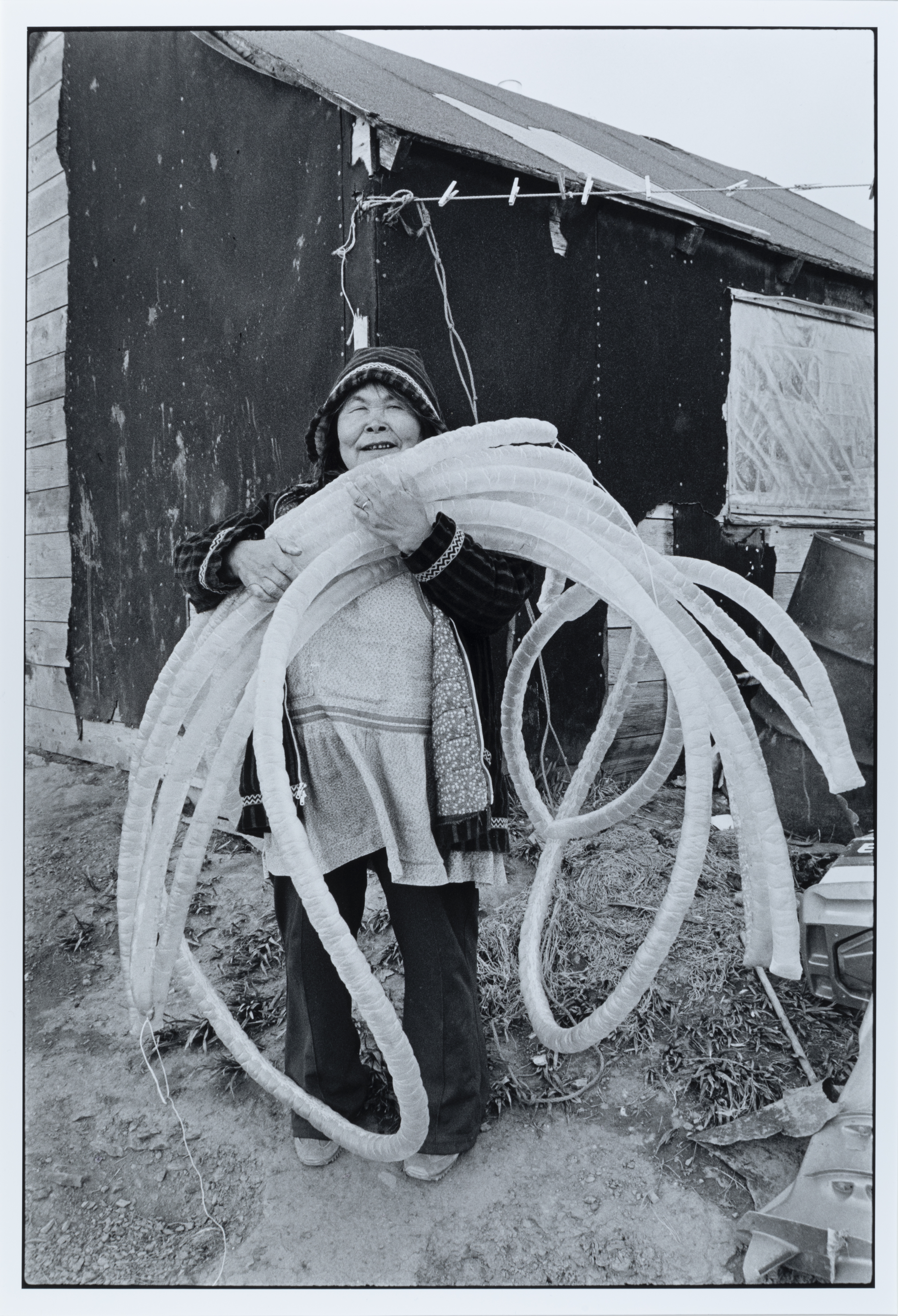 Untitled (Francis Usugan of Toksook Bay holds dried seal gut), 1980